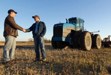 A delivery person shakes hands with a farmer after delivering Propane Refills in Woodford County IL