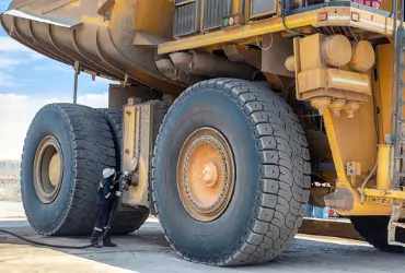 A man filling up construction equipment during gasoline delivery in McLean County IL.