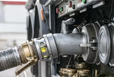 A hose attached to a fuel truck during a Fuel Delivery for Pekin IL