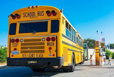 School bus filling out with gasoline at the gas station for Gasoline Delivery in Washington IL