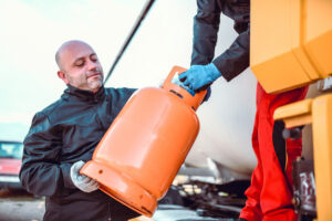 Is Propane Safe to Use? Answers For Your Burning Energy Questions 2 A man grabs a tank of propane after getting answers to "Is Propane safe to use"